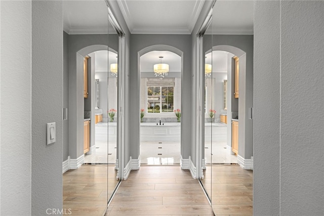 4160 New Hampshire Ave, Claremont, CA 91711 - entrance foyer featuring arched walkways, light wood-style floors, a textured wall, and ornamental molding