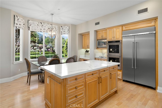 4160 New Hampshire Ave, Claremont, CA 91711 - kitchen with built in appliances, a chandelier, light wood-type flooring, and a center island
