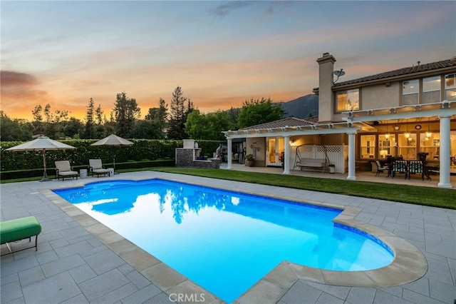 4160 New Hampshire Ave, Claremont, CA 91711 - pool at dusk featuring a patio, outdoor dining space, and an outdoor living space
