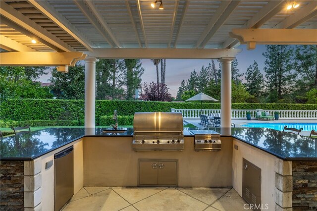 4160 New Hampshire Ave, Claremont, CA 91711 - patio terrace at dusk with a sink, a patio area, and a community pool