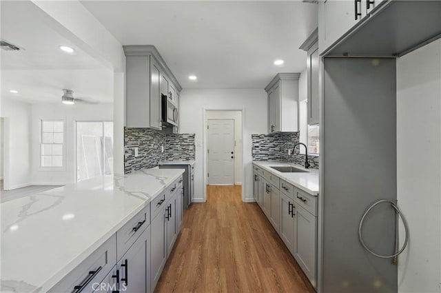 1509 W 138th St, Compton, CA 90222 - kitchen featuring a sink, gray cabinets, stainless steel microwave, recessed lighting, and wood finished floors