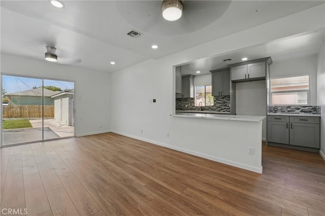 1509 W 138th St, Compton, CA 90222 - unfurnished living room with ceiling fan, wood finished floors, baseboards, a sink, and recessed lighting