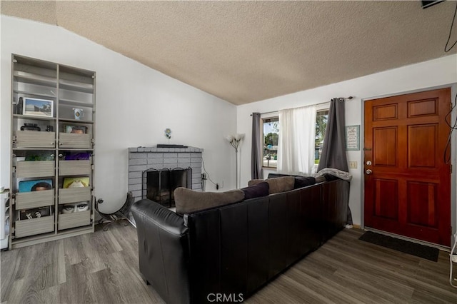 23621 Suncrest Ave, Moreno Valley, CA 92553 - living room featuring wood finished floors, a fireplace, a textured ceiling, and lofted ceiling