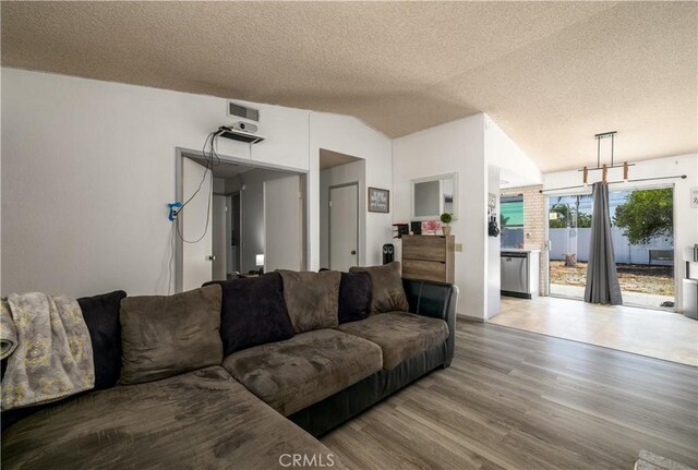 23621 Suncrest Ave, Moreno Valley, CA 92553 - living area featuring wood finished floors, vaulted ceiling, and a textured ceiling