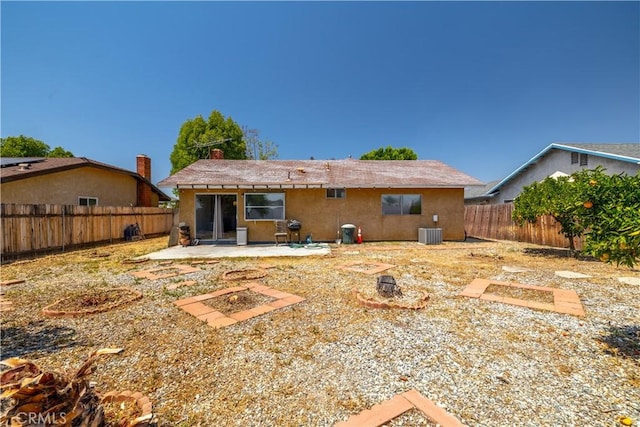 23621 Suncrest Ave, Moreno Valley, CA 92553 - rear view of property featuring cooling unit, a patio, a fenced backyard, stucco siding, and an outdoor fire pit