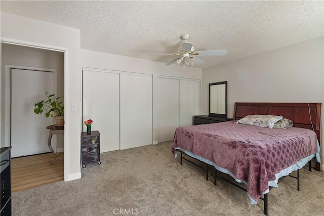 7558 Lobos Ave, Hesperia, CA 92345 - carpeted bedroom featuring multiple closets, ceiling fan, and a textured ceiling