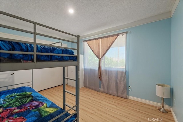 7558 Lobos Ave, Hesperia, CA 92345 - bedroom with a textured ceiling and wood finished floors