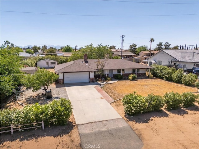 7558 Lobos Ave, Hesperia, CA 92345 - ranch-style house with concrete driveway, an attached garage, and a residential view