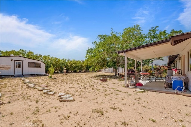 7558 Lobos Ave, Hesperia, CA 92345 - view of yard featuring a patio area and an outdoor structure