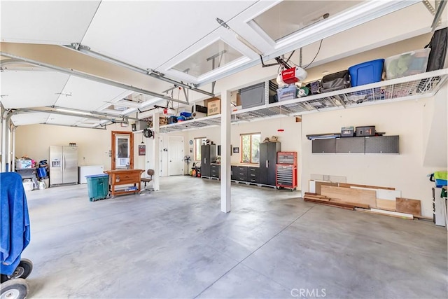 26525 Carancho Rd, Temecula, CA 92590 - garage with refrigerator with ice dispenser and a garage door opener