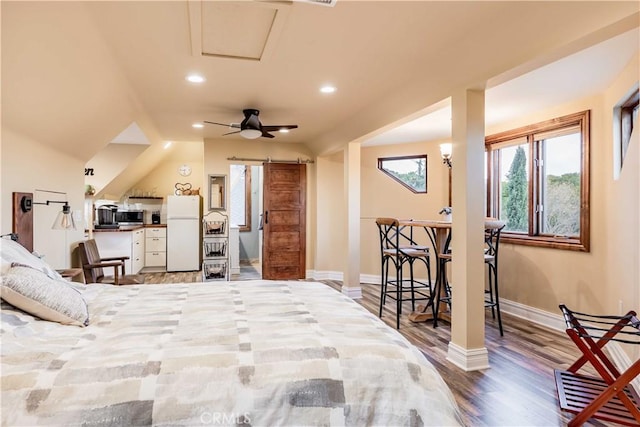 26525 Carancho Rd, Temecula, CA 92590 - bedroom with freestanding refrigerator, a barn door, wood finished floors, baseboards, and recessed lighting