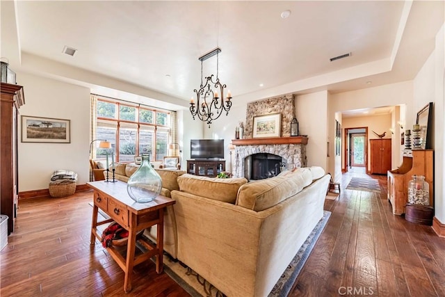 26525 Carancho Rd, Temecula, CA 92590 - living room featuring dark wood finished floors, baseboards, a stone fireplace, and a chandelier