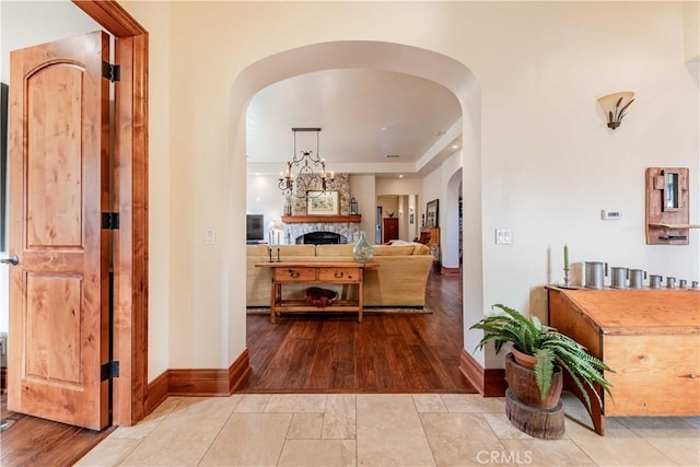 26525 Carancho Rd, Temecula, CA 92590 - hallway with arched walkways, baseboards, and wood finished floors