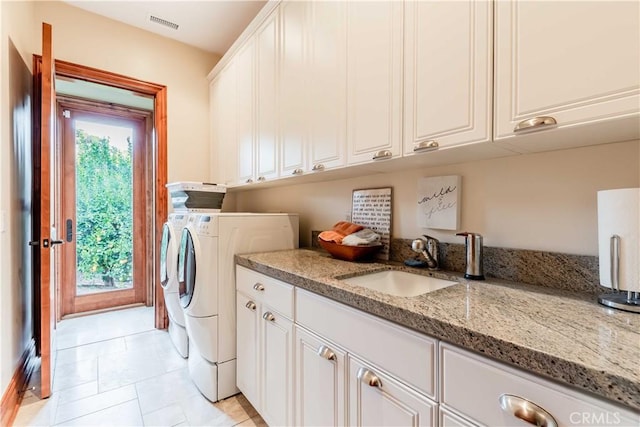 26525 Carancho Rd, Temecula, CA 92590 - laundry area with cabinet space, washer and dryer, and light tile patterned flooring