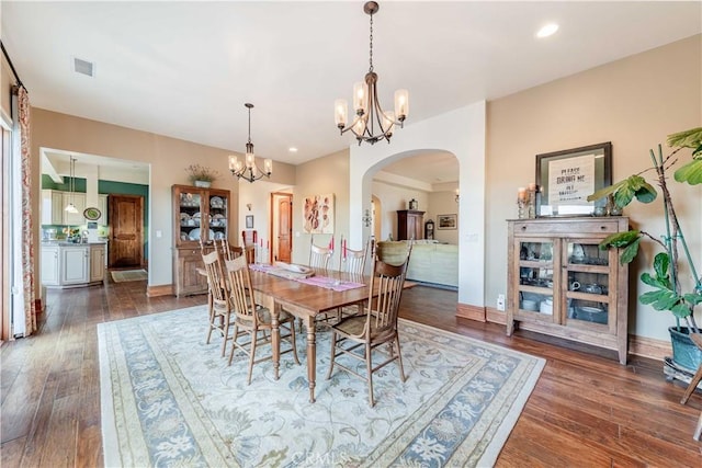 26525 Carancho Rd, Temecula, CA 92590 - dining area featuring arched walkways, a chandelier, dark wood-style floors, recessed lighting, and baseboards