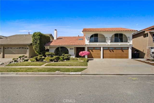17805 Winterberry St, Fountain Valley, CA 92708 - mediterranean / spanish-style home with concrete driveway, a garage, stucco siding, and a tiled roof