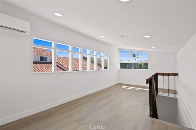 17805 Winterberry St, Fountain Valley, CA 92708 - spare room with a wall unit AC, wood finished floors, baseboards, and recessed lighting