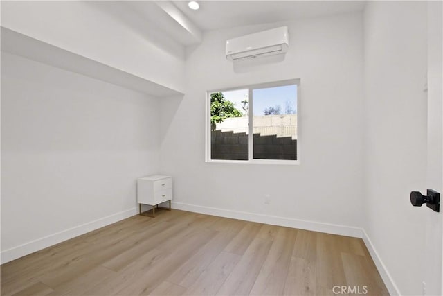 17805 Winterberry St, Fountain Valley, CA 92708 - spare room with an AC wall unit, baseboards, and wood finished floors