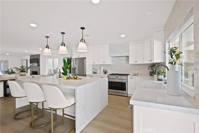 17805 Winterberry St, Fountain Valley, CA 92708 - kitchen with appliances with stainless steel finishes, a sink, range hood, plenty of natural light, and recessed lighting