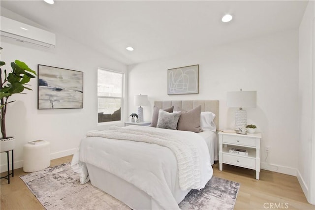 17805 Winterberry St, Fountain Valley, CA 92708 - bedroom featuring a wall unit AC, light wood finished floors, baseboards, and recessed lighting