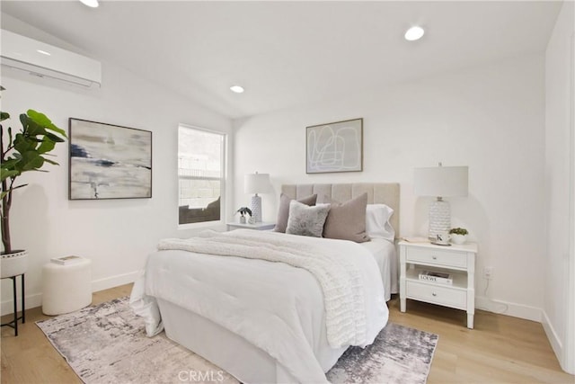 17805 Winterberry St, Fountain Valley, CA 92708 - bedroom featuring a wall unit AC, light wood-style floors, and recessed lighting