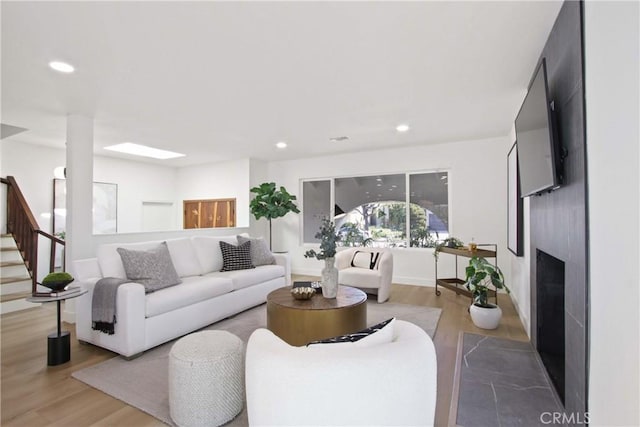 17805 Winterberry St, Fountain Valley, CA 92708 - living area featuring a fireplace, recessed lighting, wood finished floors, and stairs