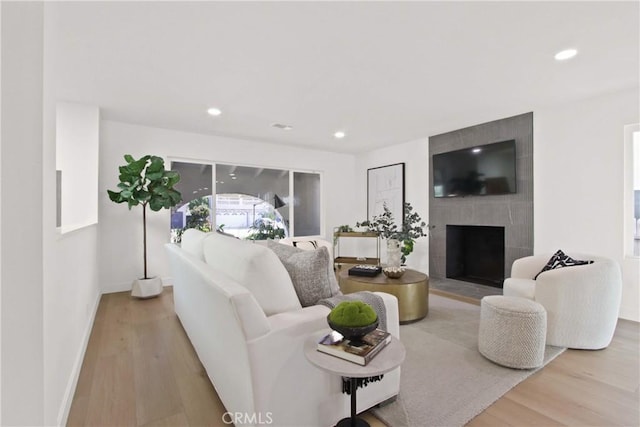 17805 Winterberry St, Fountain Valley, CA 92708 - living area with wood finished floors, a tile fireplace, baseboards, and recessed lighting
