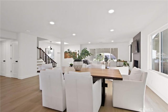 17805 Winterberry St, Fountain Valley, CA 92708 - dining room with light wood finished floors, stairs, recessed lighting, baseboards, and a fireplace
