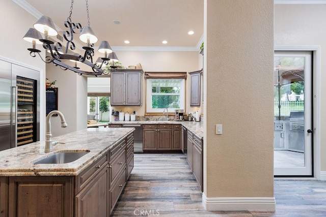 30801 Via Conquista, San Juan Capistrano, CA 92675 - kitchen with a sink, ornamental molding, a chandelier, dishwasher, and beverage cooler