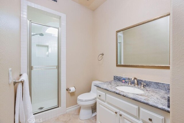 30801 Via Conquista, San Juan Capistrano, CA 92675 - bathroom with vanity, toilet, a stall shower, and tile patterned flooring