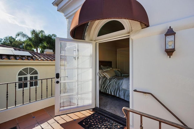 30801 Via Conquista, San Juan Capistrano, CA 92675 - doorway to property featuring stucco siding and roof mounted solar panels