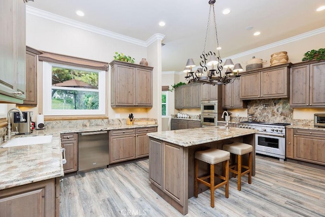 30801 Via Conquista, San Juan Capistrano, CA 92675 - kitchen featuring appliances with stainless steel finishes, a sink, light wood-type flooring, healthy amount of natural light, and crown molding