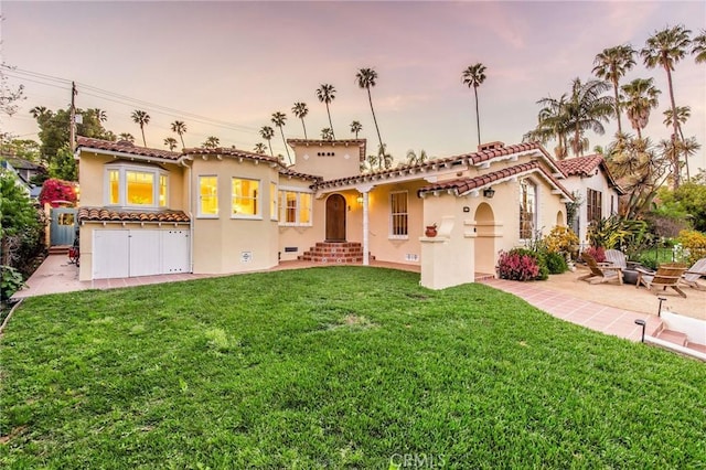 209 Ximeno Ave, Long Beach, CA 90803 - mediterranean / spanish-style home with stucco siding, a front yard, an outdoor fire pit, and a tile roof