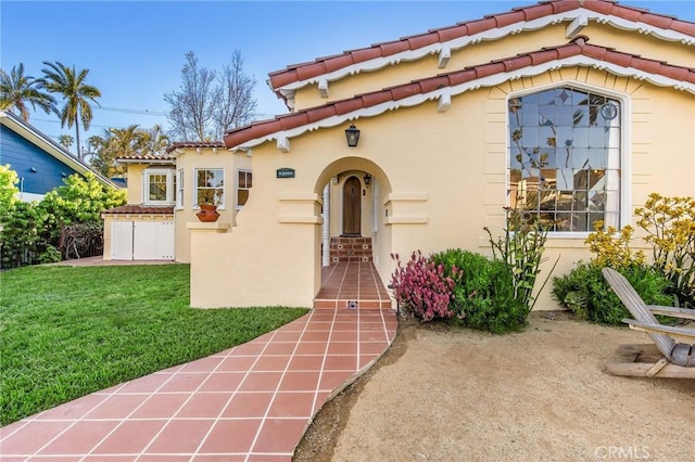 209 Ximeno Ave, Long Beach, CA 90803 - mediterranean / spanish home with stucco siding, a tile roof, and a front lawn