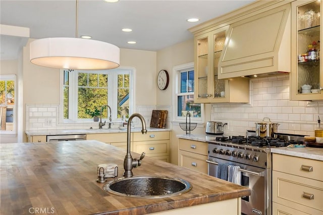 209 Ximeno Ave, Long Beach, CA 90803 - kitchen with appliances with stainless steel finishes, butcher block counters, a sink, cream cabinetry, and recessed lighting