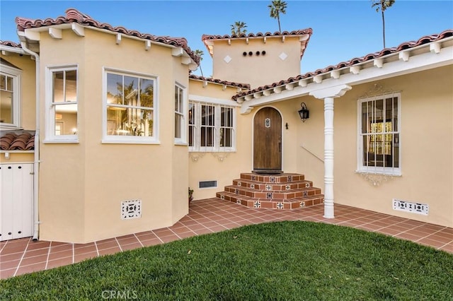 209 Ximeno Ave, Long Beach, CA 90803 - property entrance featuring stucco siding, a tiled roof, and a yard