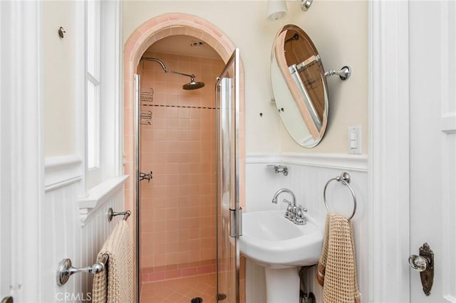 209 Ximeno Ave, Long Beach, CA 90803 - bathroom with a stall shower, wainscoting, and a decorative wall