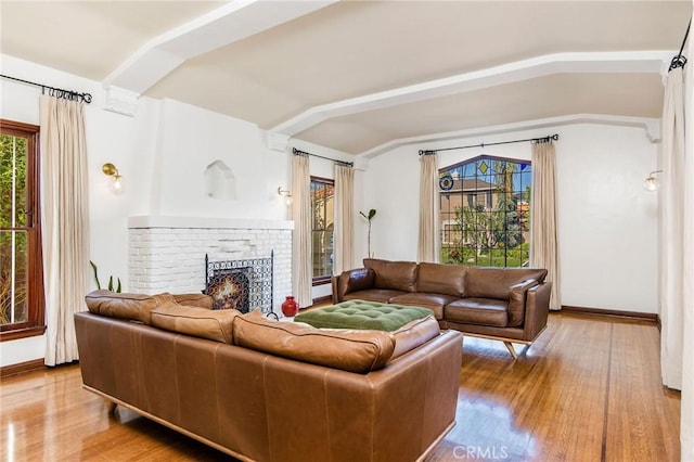 209 Ximeno Ave, Long Beach, CA 90803 - living area with vaulted ceiling, wood finished floors, a fireplace, and baseboards