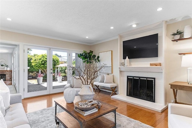 435 Orlena Ave, Long Beach, CA 90814 - living room featuring a brick fireplace, ornamental molding, recessed lighting, wood finished floors, and a textured ceiling