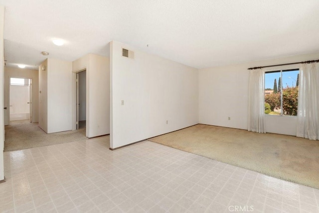 2740 Whitney St, San Diego, CA 92111 - empty room featuring plenty of natural light, light flooring, light colored carpet, and baseboards