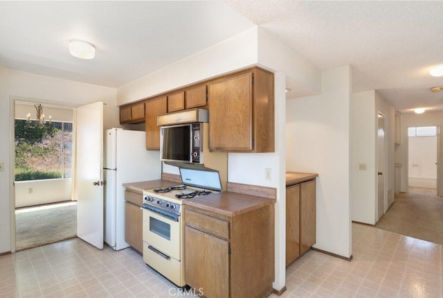 2740 Whitney St, San Diego, CA 92111 - kitchen with white appliances, healthy amount of natural light, and light flooring