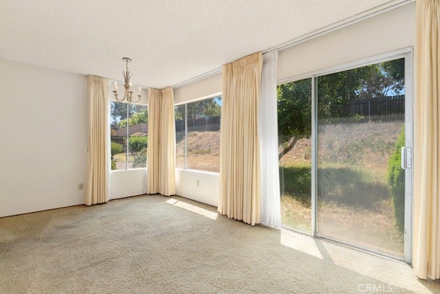 2740 Whitney St, San Diego, CA 92111 - unfurnished dining area featuring a chandelier, carpet floors, and a textured ceiling