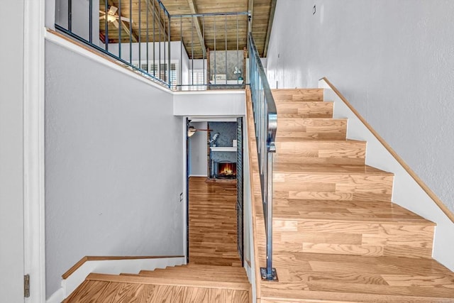1905 Alga Rd Unit C, Carlsbad, CA 92009 - stairway with a lit fireplace and a high ceiling