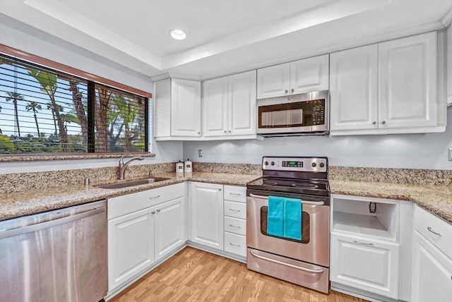 1905 Alga Rd Unit C, Carlsbad, CA 92009 - kitchen featuring appliances with stainless steel finishes, a sink, light wood-style floors, white cabinets, and recessed lighting