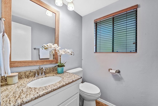 1905 Alga Rd Unit C, Carlsbad, CA 92009 - bathroom with toilet, vanity, wood finished floors, and baseboards