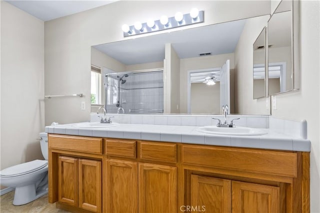 917 Saint Ann, Paso Robles, CA 93446 - bathroom with a shower with shower door, double vanity, toilet, and a ceiling fan
