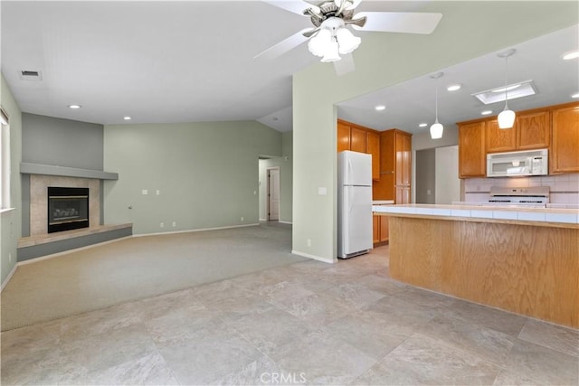 917 Saint Ann, Paso Robles, CA 93446 - kitchen with white appliances, tile counters, vaulted ceiling, pendant lighting, and baseboards