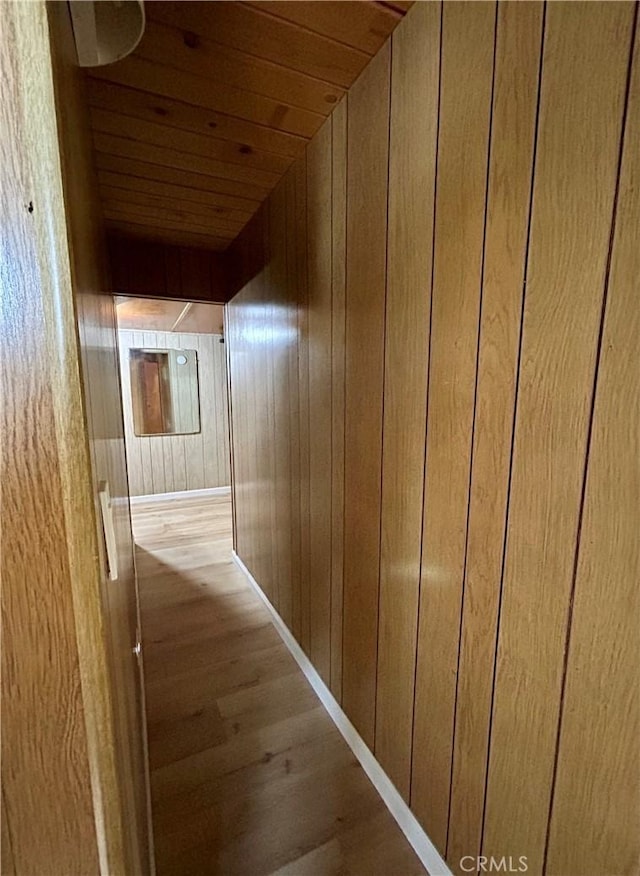 2484 Pine Dr, Running Springs, CA 92382 - hallway with wood finished floors, wood ceiling, wooden walls, and baseboards