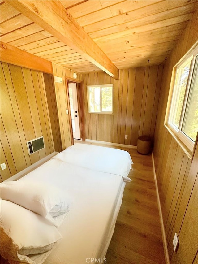 2484 Pine Dr, Running Springs, CA 92382 - bedroom with wood walls, wood finished floors, wood ceiling with exposed beams, and baseboards