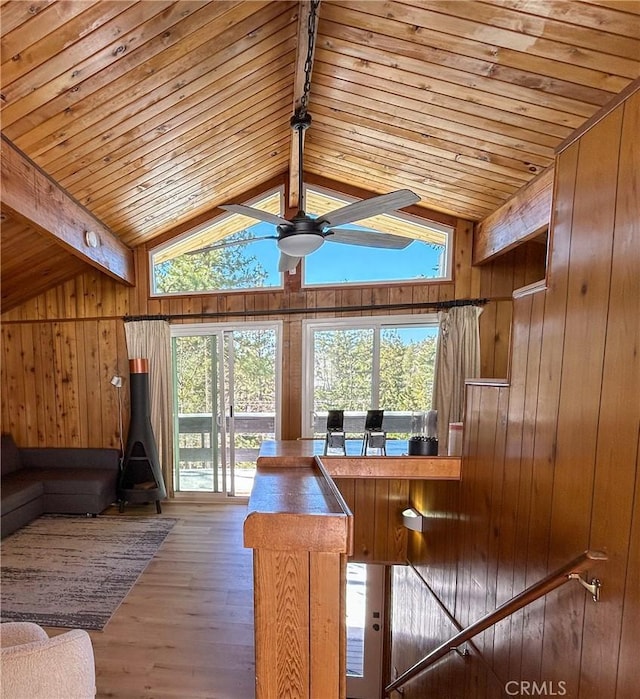 2484 Pine Dr, Running Springs, CA 92382 - living room featuring wooden walls, wooden ceiling, healthy amount of natural light, a ceiling fan, and wood finished floors